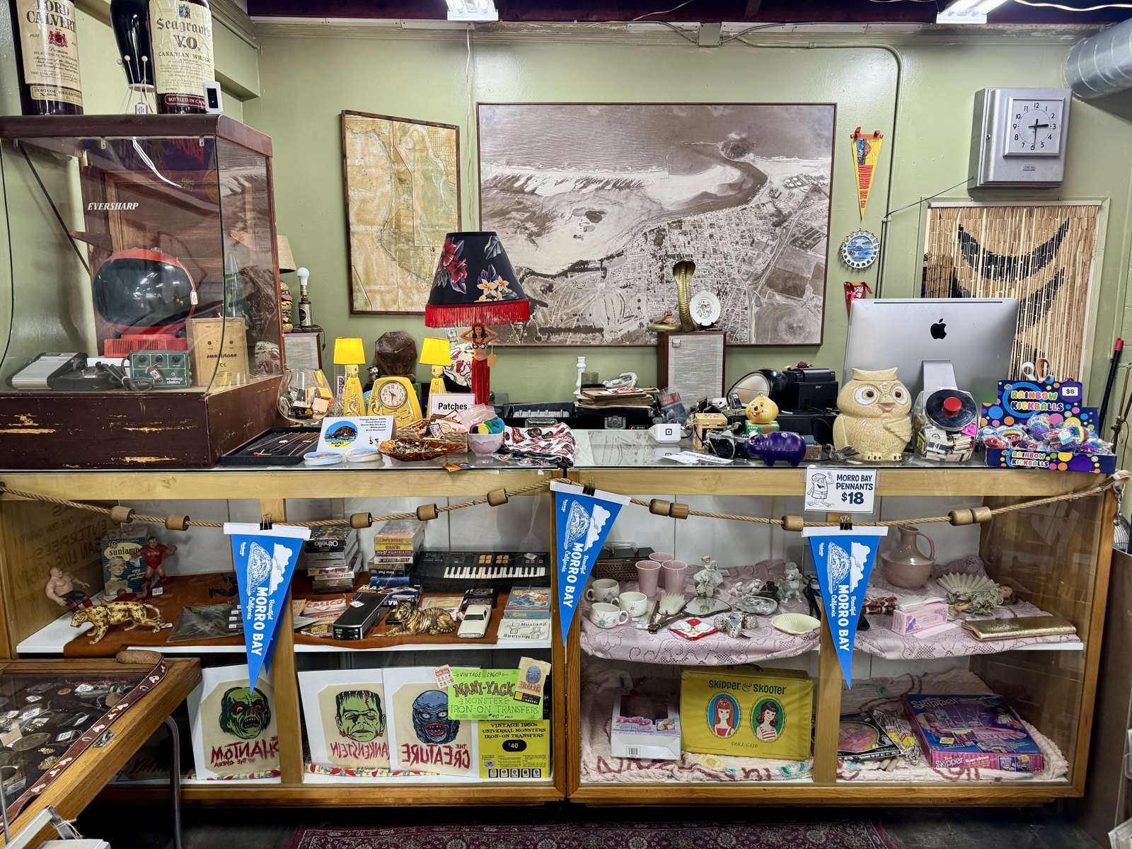 Front counter display with small collectibles and records at Beachcomber Vintage.